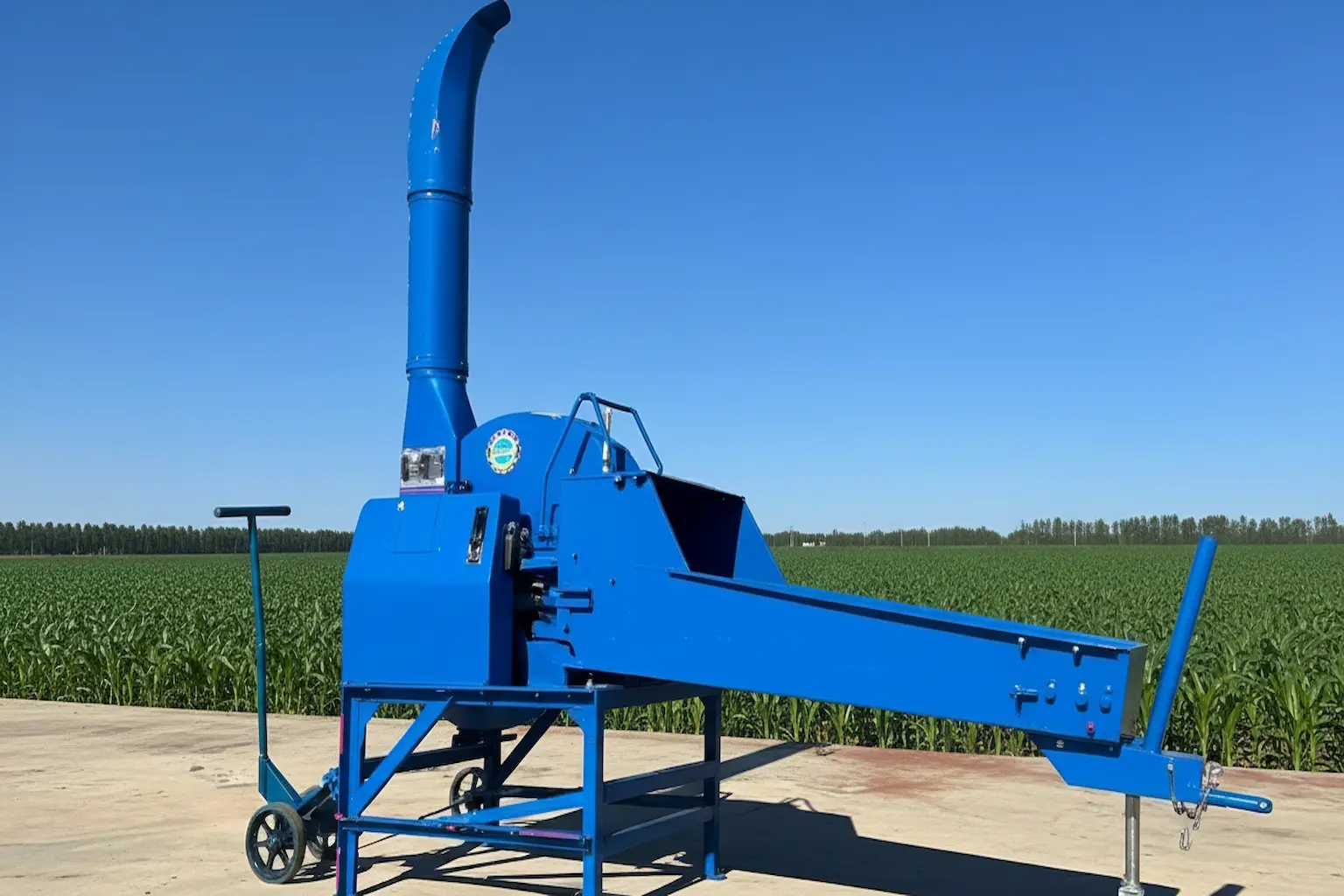 Blue chaff cutter for silage; boosts farm efficiency with fast forage shredding.