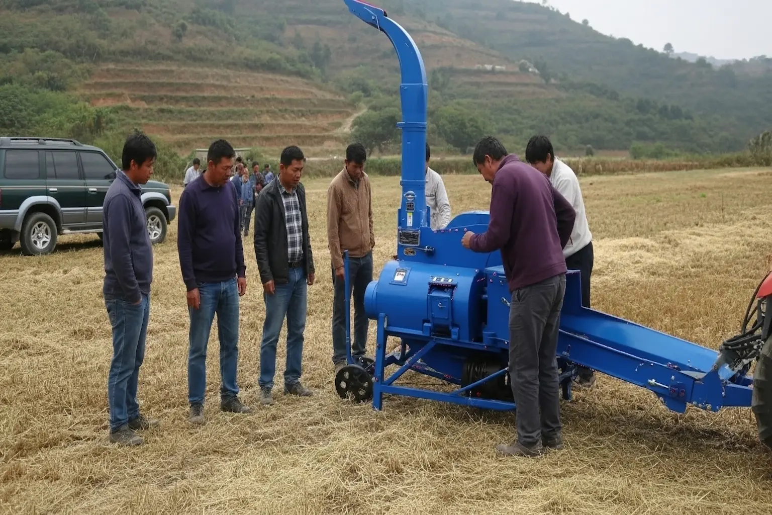 Professional customer service Farmers inspecting a blue chaff cutter machine