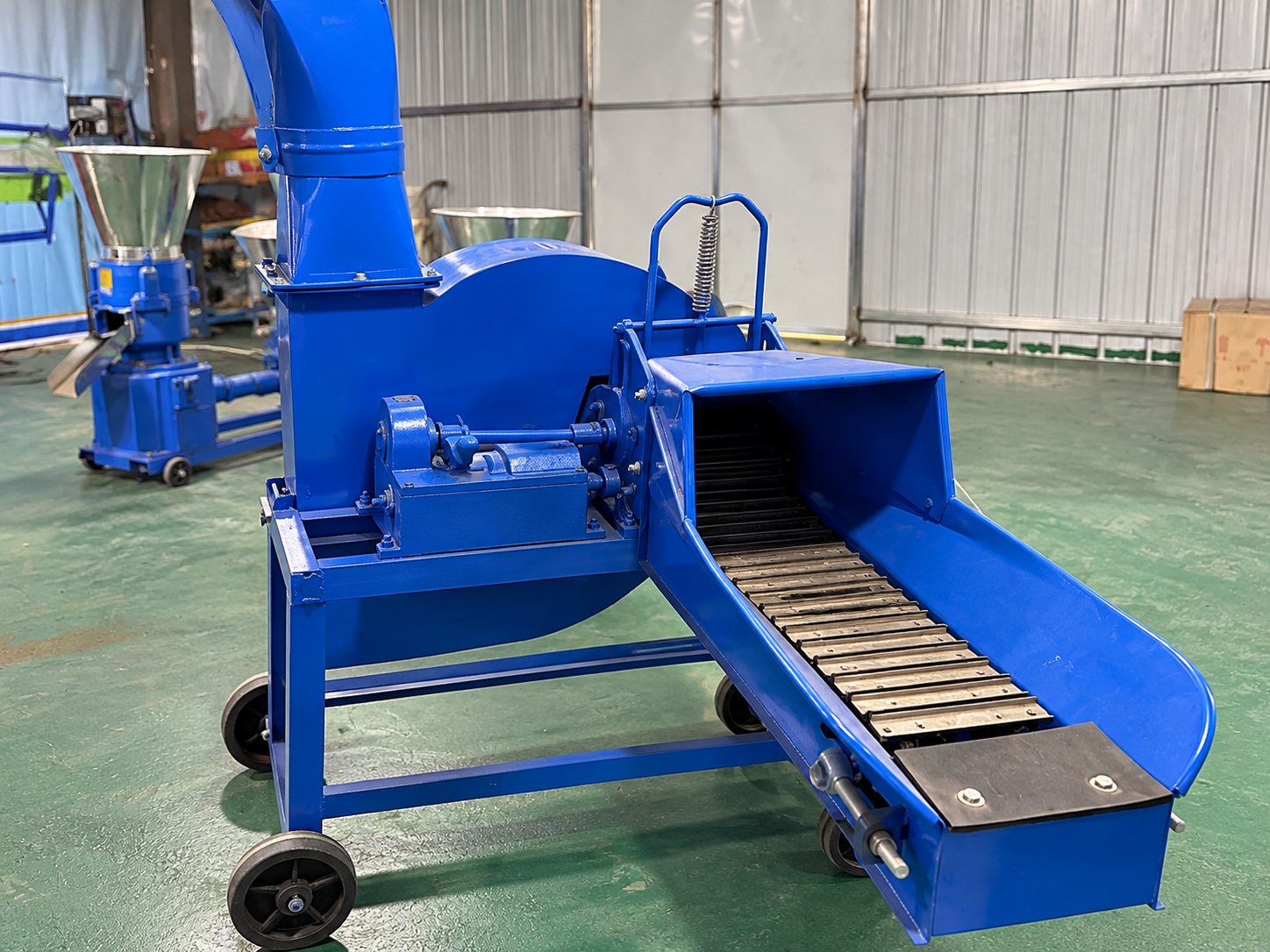 The feed path and operator position of a stopped blue forage chopper