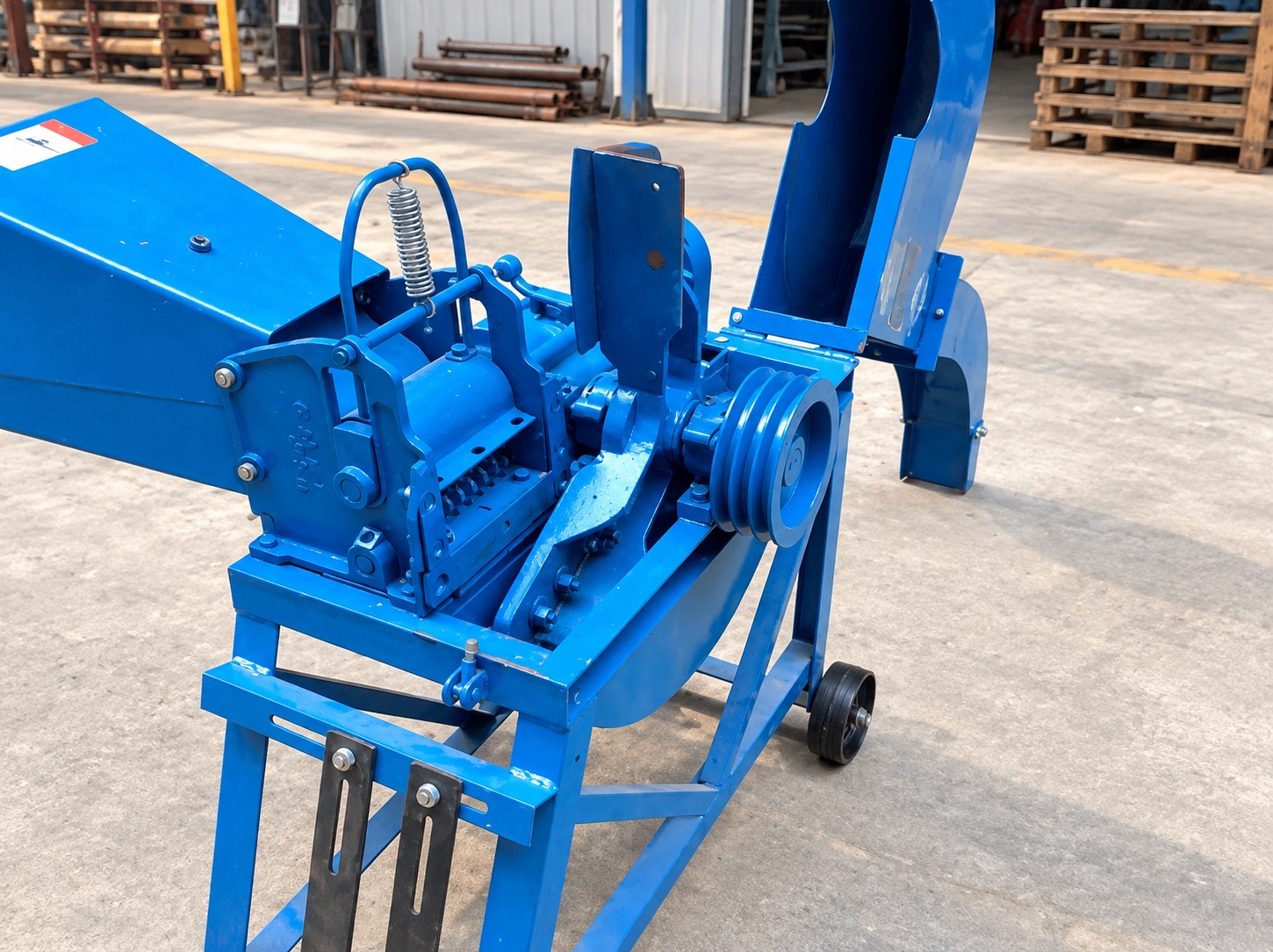Drive pulleys, adjustment points, and frame on the supplied blue equipment during a stopped inspection