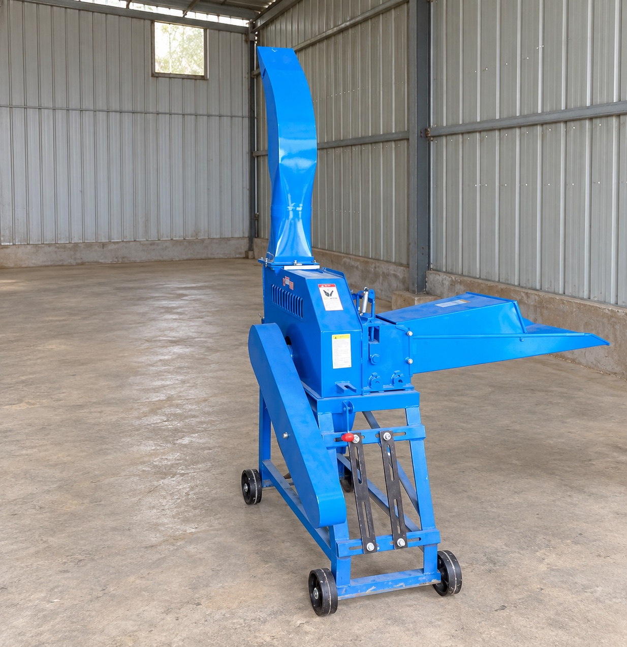 Stationary blue forage equipment with access space, feed tray, and side drive cover
