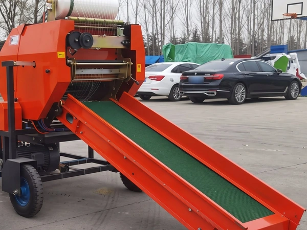Net roll mounted above the FC-585 baling chamber with the green belt feed conveyor below