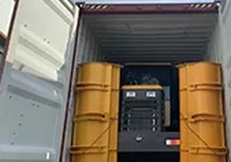 Loader with wheels removed and stowed beside it in a container to save space