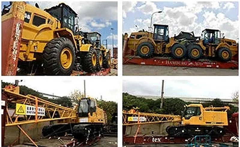 Wheel loaders lashed onto flat rack containers at the port